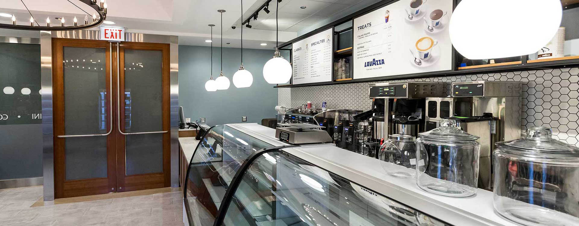 A restaurant with many lights hanging above the counter.