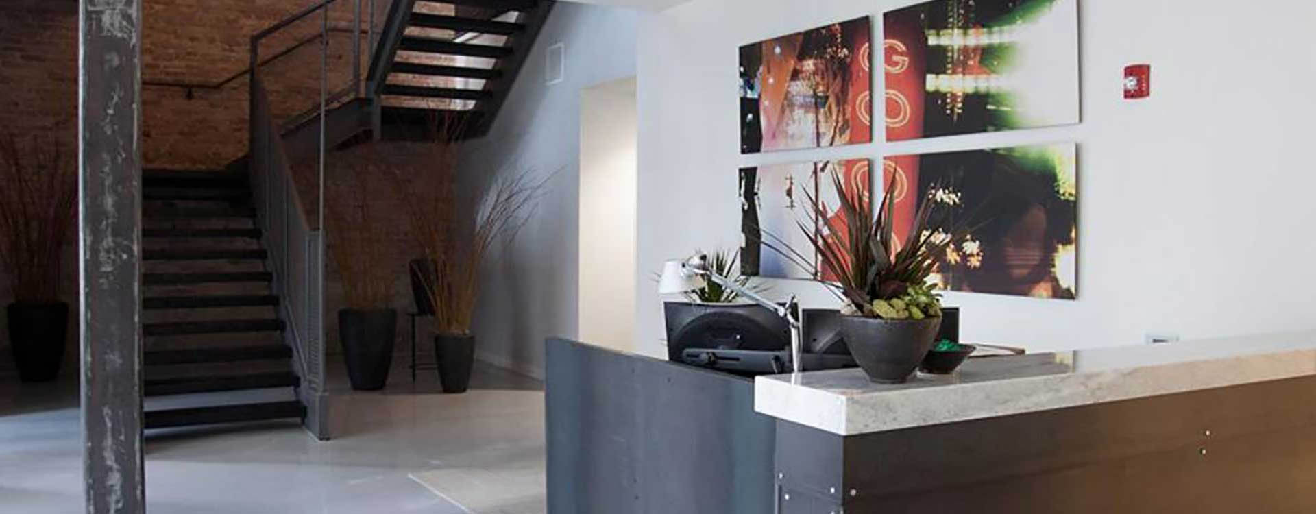A lobby with a plant and a picture on the wall
