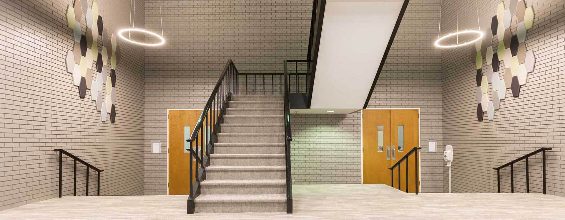 A staircase with metal railing and wood steps.