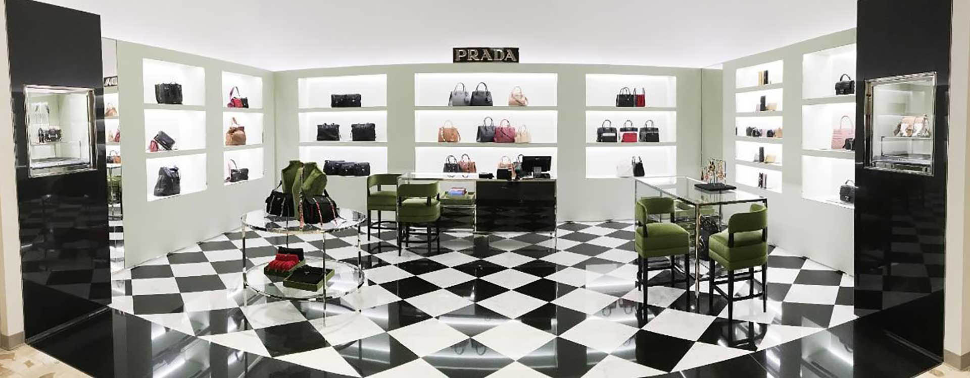A black and white checkered floor with several bags on display.