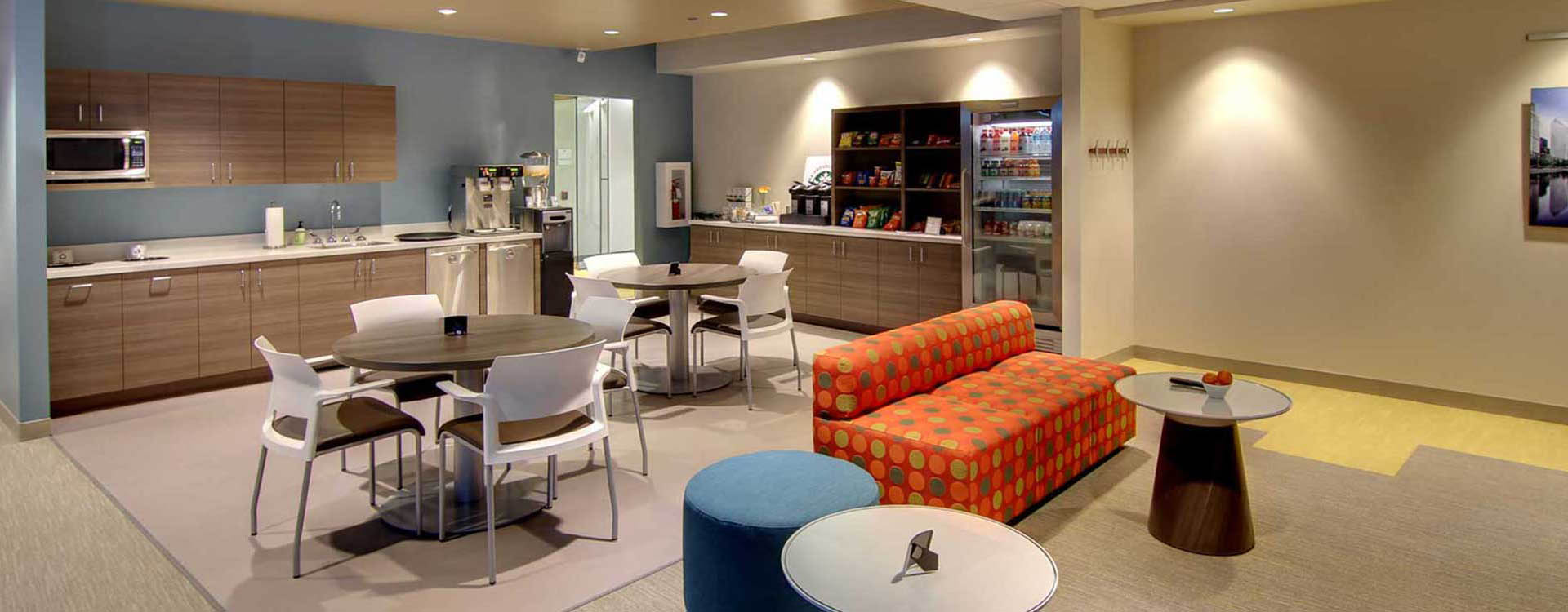 A room with couches, tables and chairs.